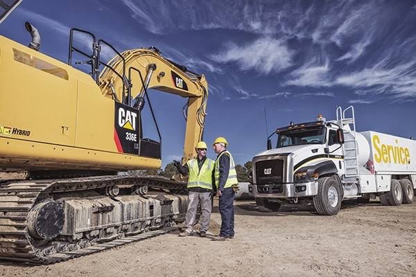Excavator technician using service repair manual